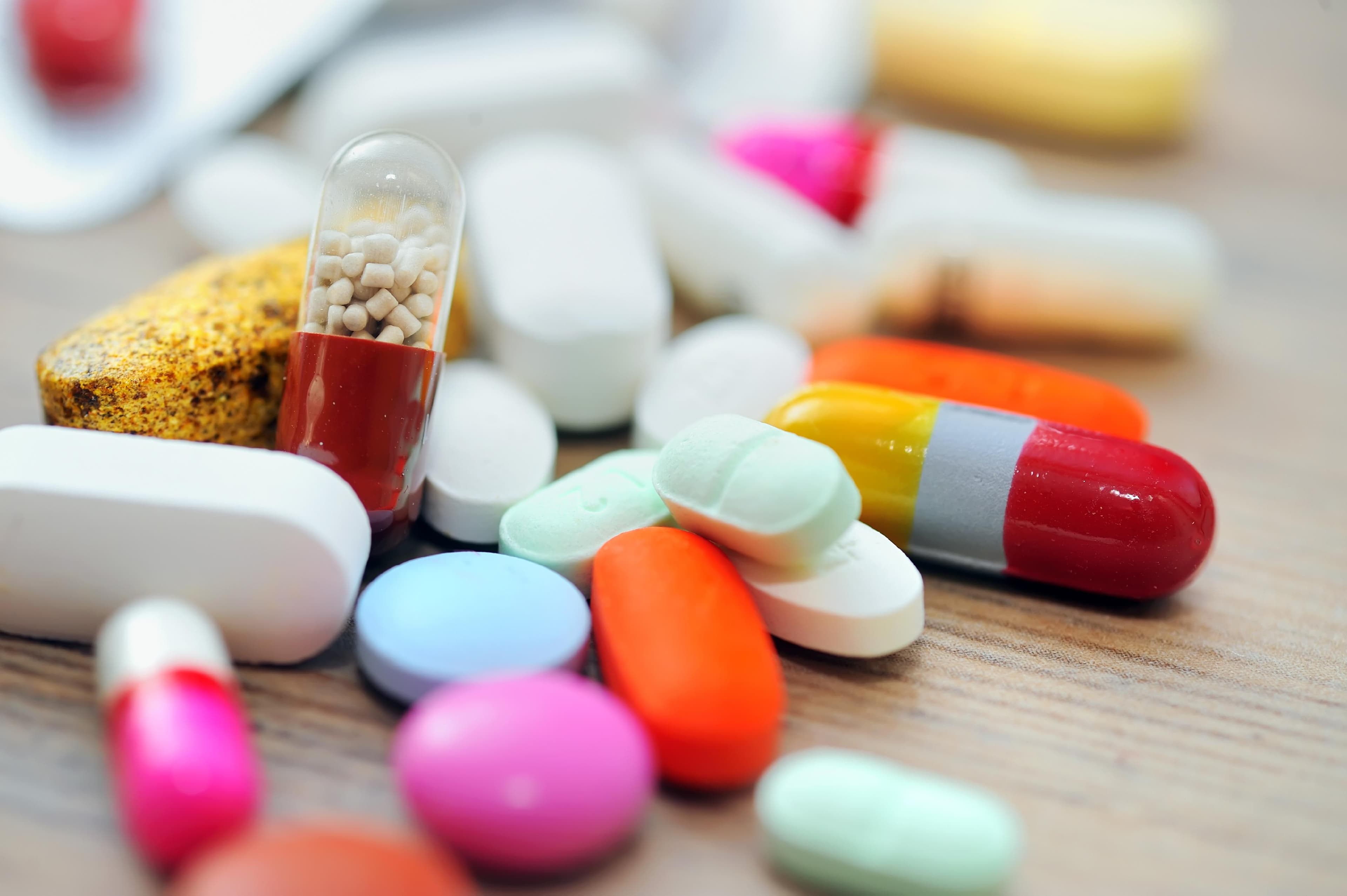 A close-up of assorted pharmaceutical tablets and capsules